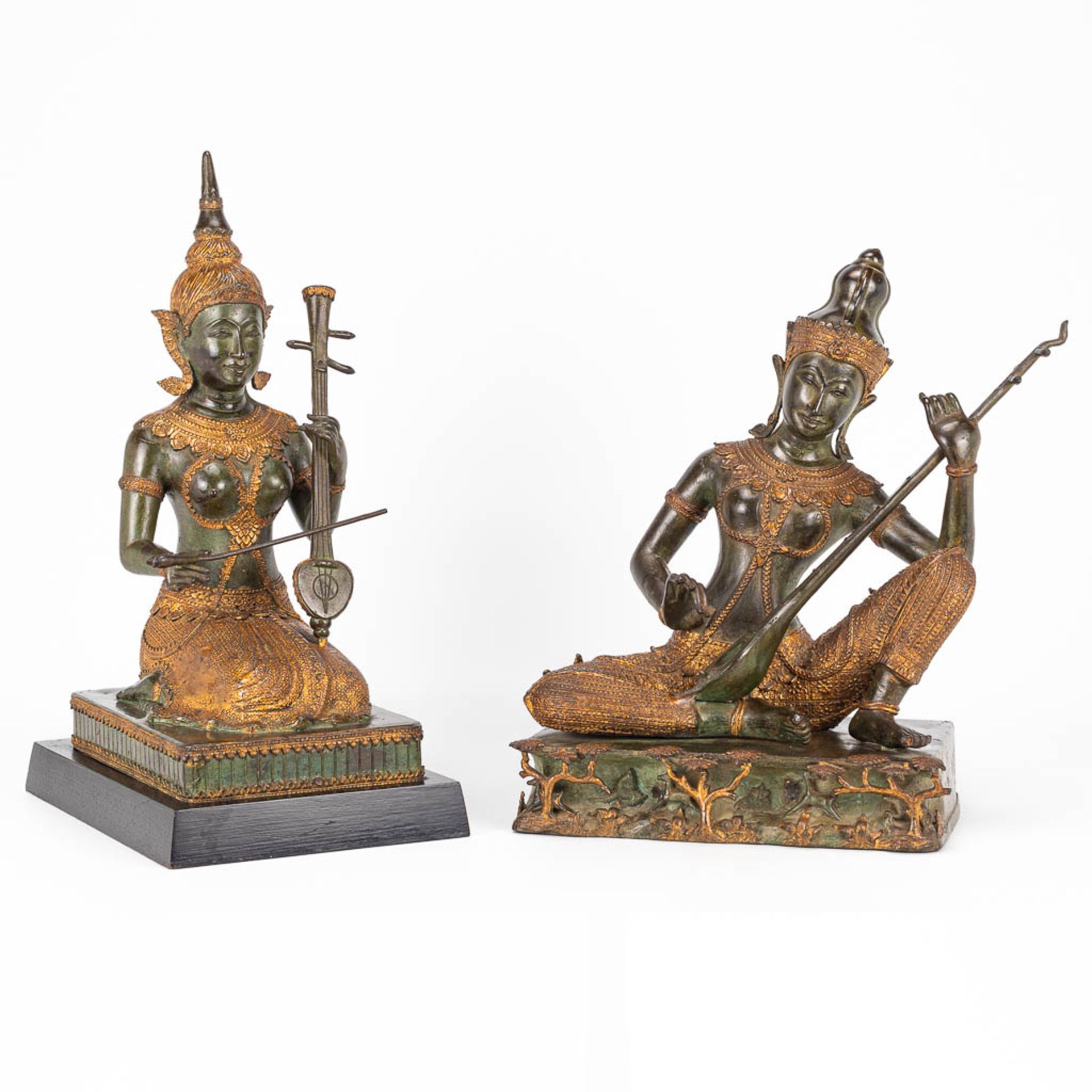 A collection of 2 oriental musical buddha's, made of metal.