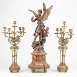 A large three-piece mantle garniture made of marble mounted with bronze, a statue made of spelter