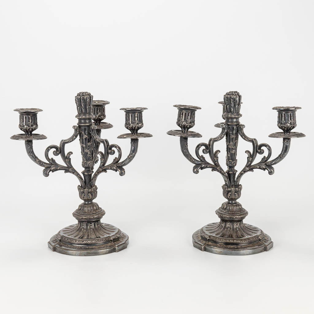 A pair of silver-plated Louis XVI-style candlesticks.