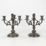 A pair of silver-plated Louis XVI-style candlesticks.
