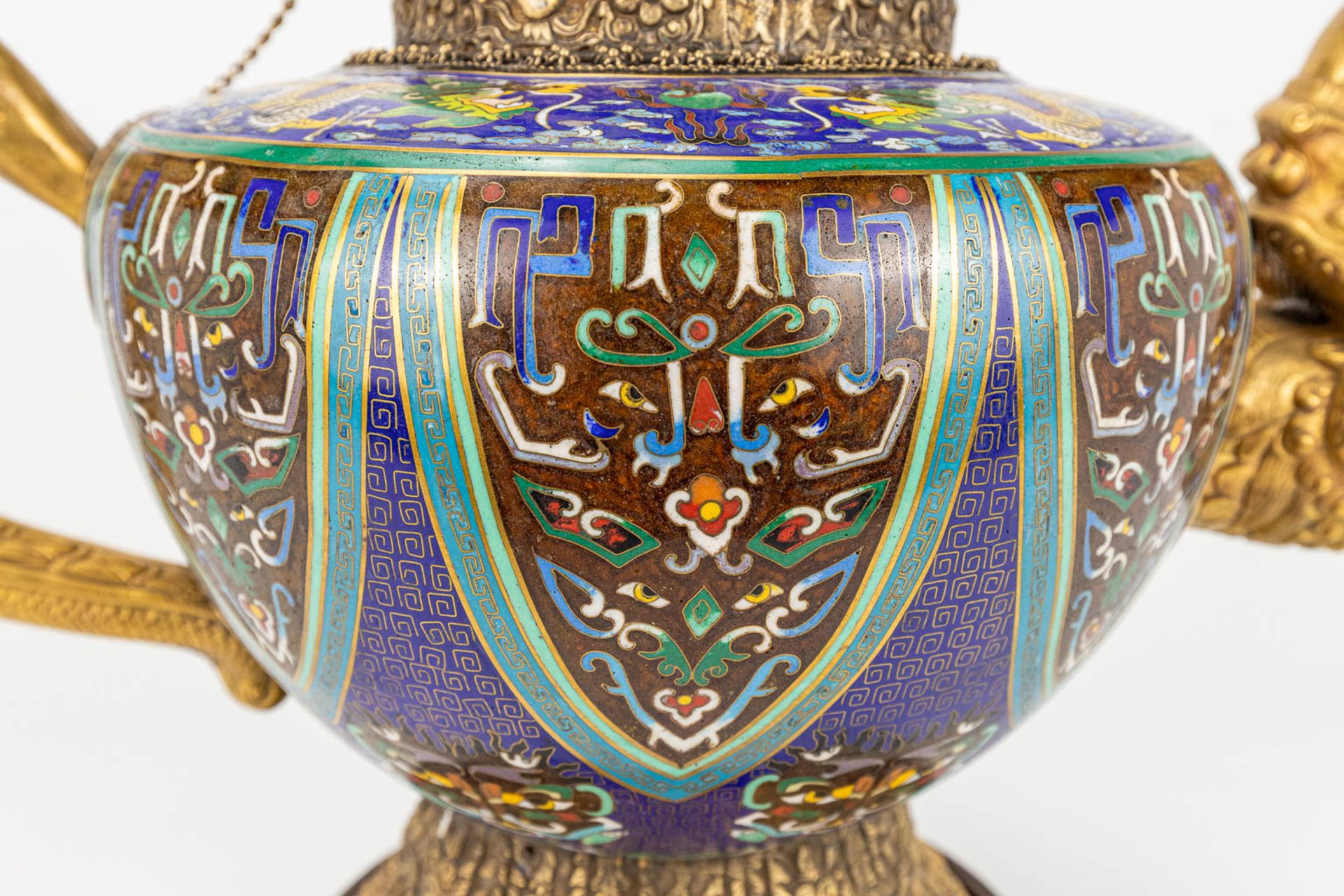 A Tibetan ceremonial ewer made of gilt bronze and finished with cloisonnŽ bronze. - Image 15 of 18