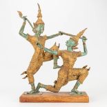 A pair of Thai dancers on a wood base.