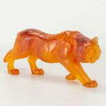 A tiger figurine made of P‰te de verre by Daum in France. Amber-colored.