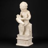 A statue of a reading boy made of alabaster.