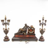 A three-piece garniture clock with candelabra, made of marble. Mounted with patinated and gilt bronz