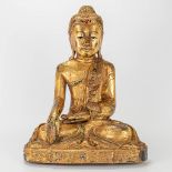 An oriental wood sculptured and gilt Buddha.