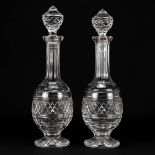 A pair of carafes or decanters made of cut crystal and marked Waterford.