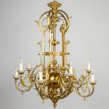 An antique and electrified gas chandelier, made of bronze