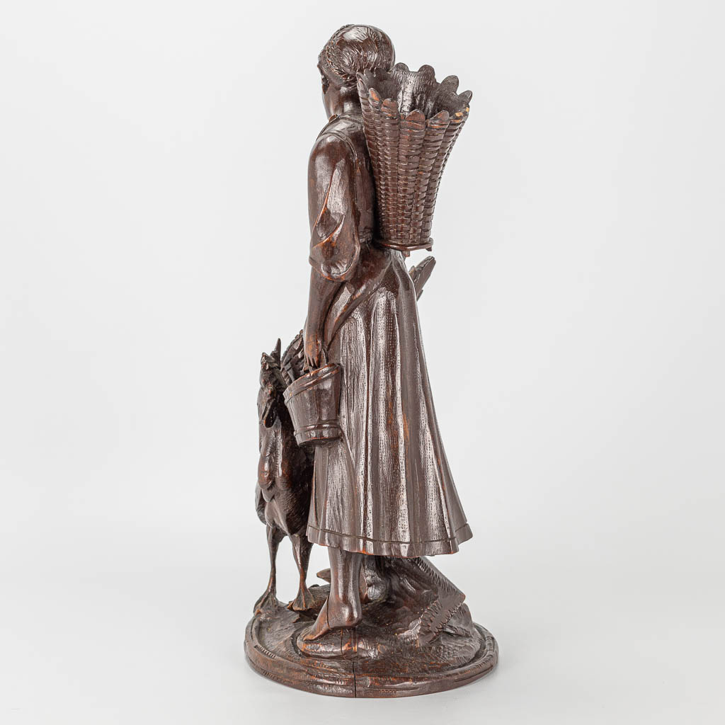 A wood sculpture of a lady with rooster, Black Forest. - Image 2 of 14