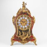 A cartel clock decorated with boulle tortoiseshell inlay and gilt bronze