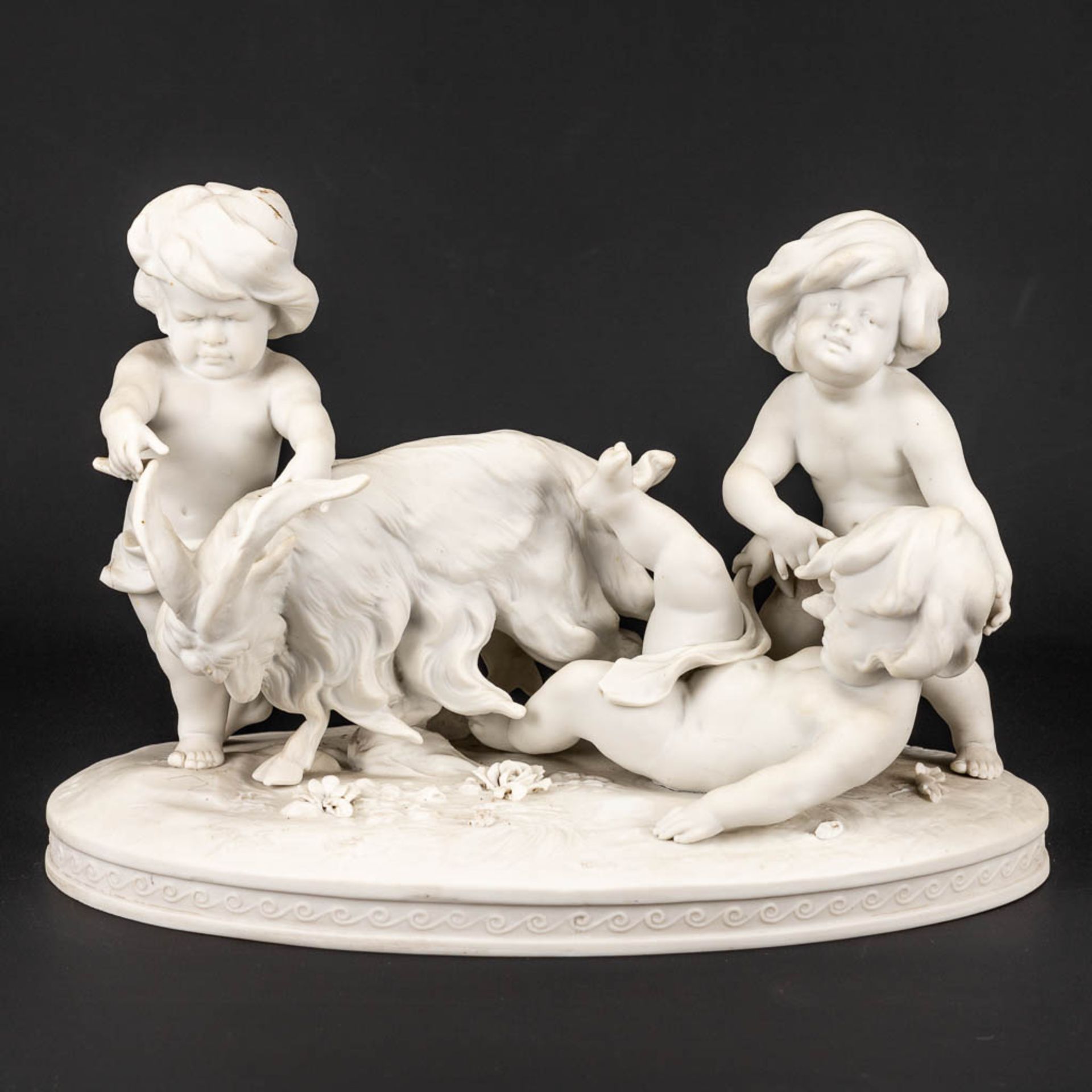A group of kids and a goat made of biscuit porcelain and marked Richard Eckert& Co, Volkstedt.
