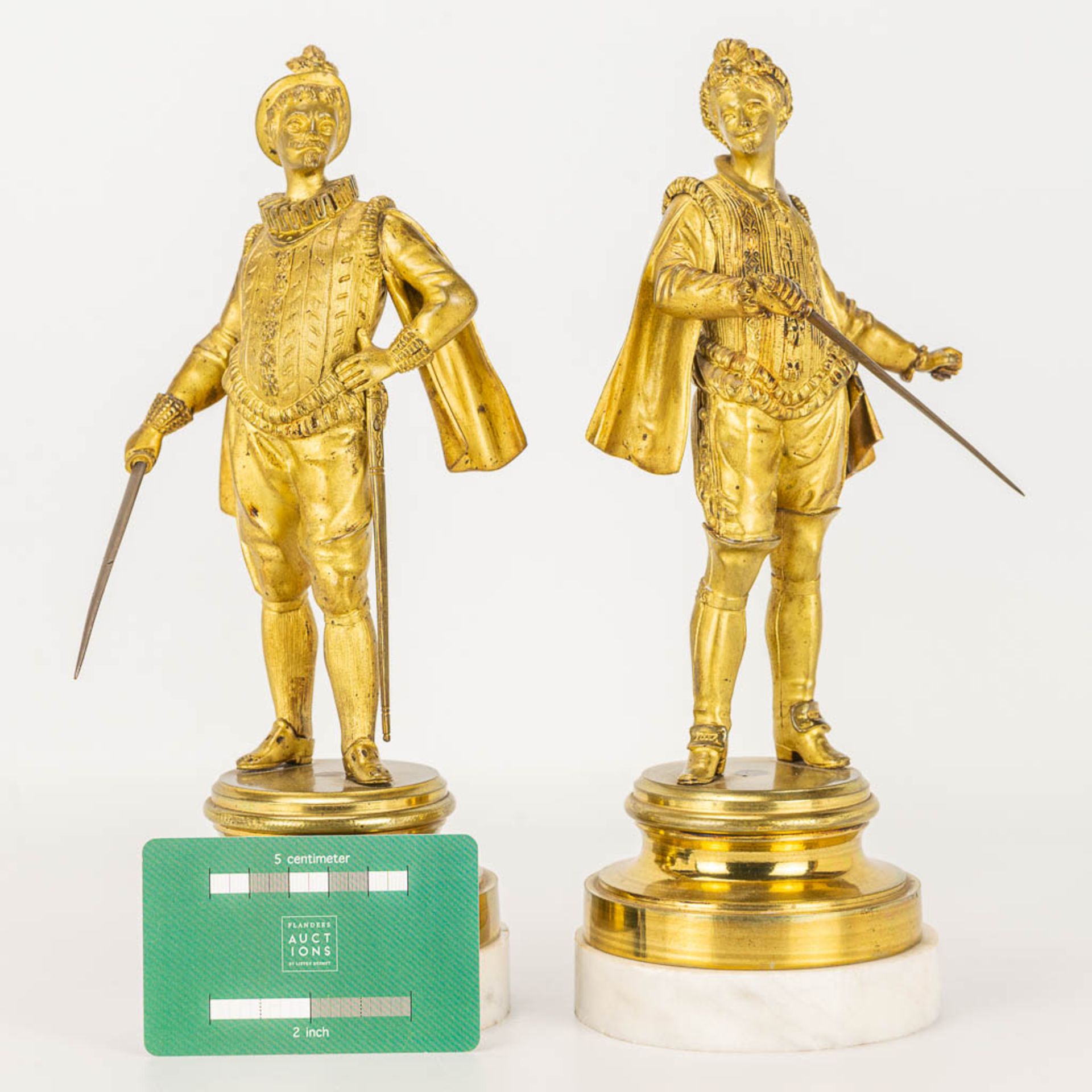 A pair of gilt Conquistadores statues made of gilt bronze and standing on a white marble base. - Image 6 of 9