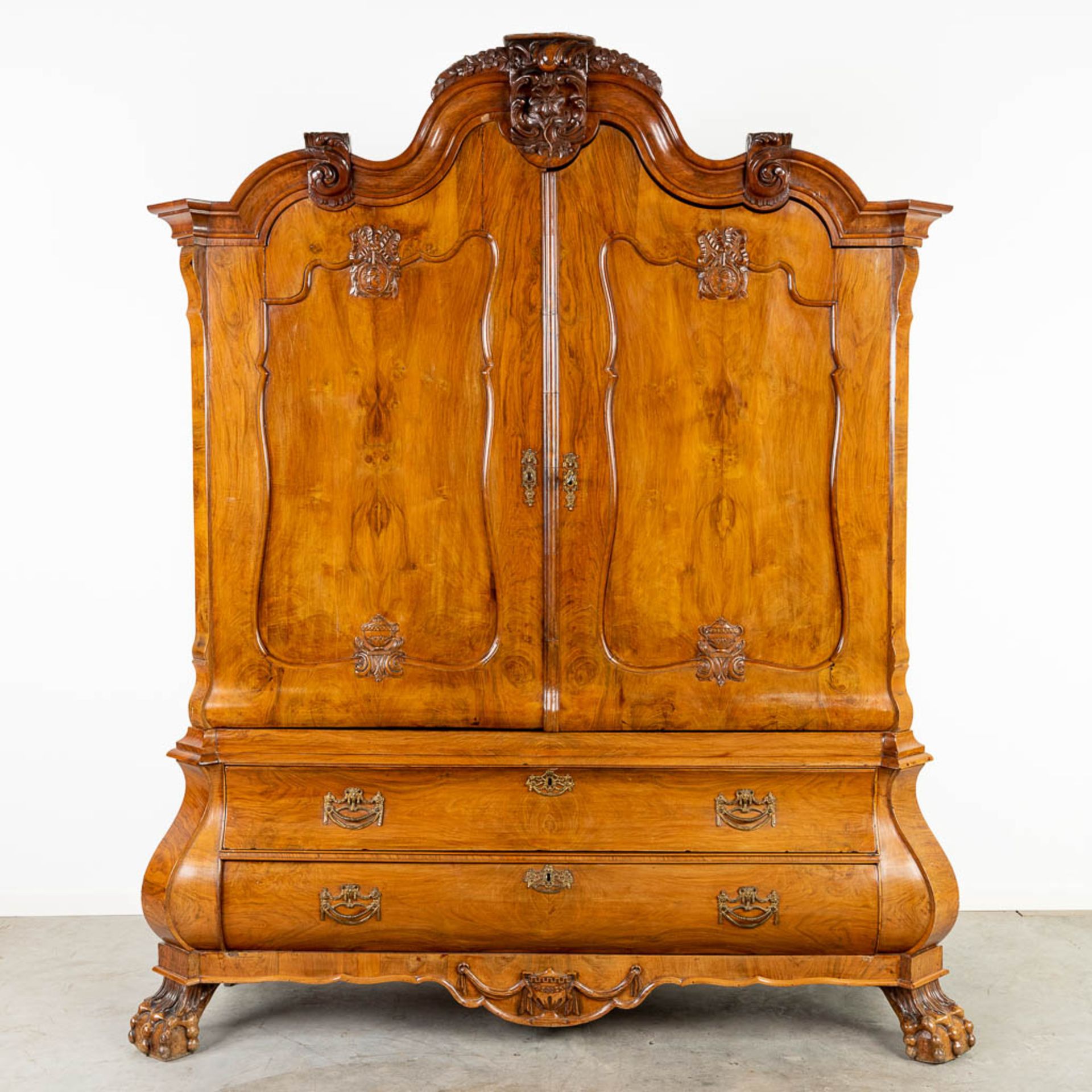 A Dutch cabinet decorated with medallions and wood sculptures