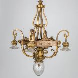 A large chandelier made of bronze in Louis XVI style.