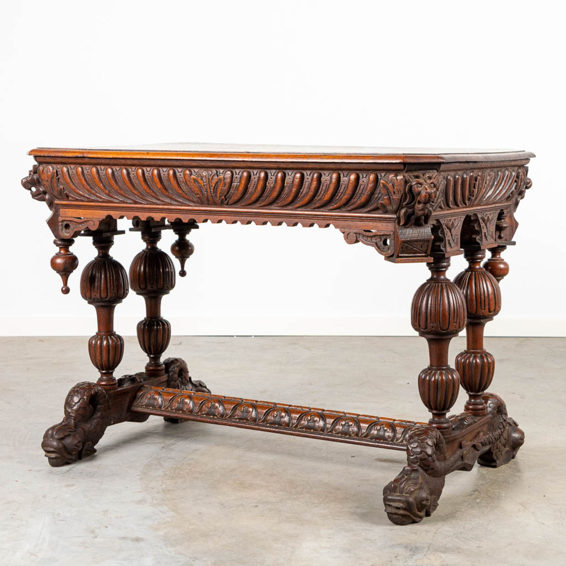 A desk made of oak and decorated with wood sculptured Dolphins.