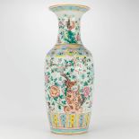 A vase made of Chinese porcleain decorated with flowers and roosters.