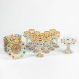 An exceptional set of goblets and plates, with hand-painted decors