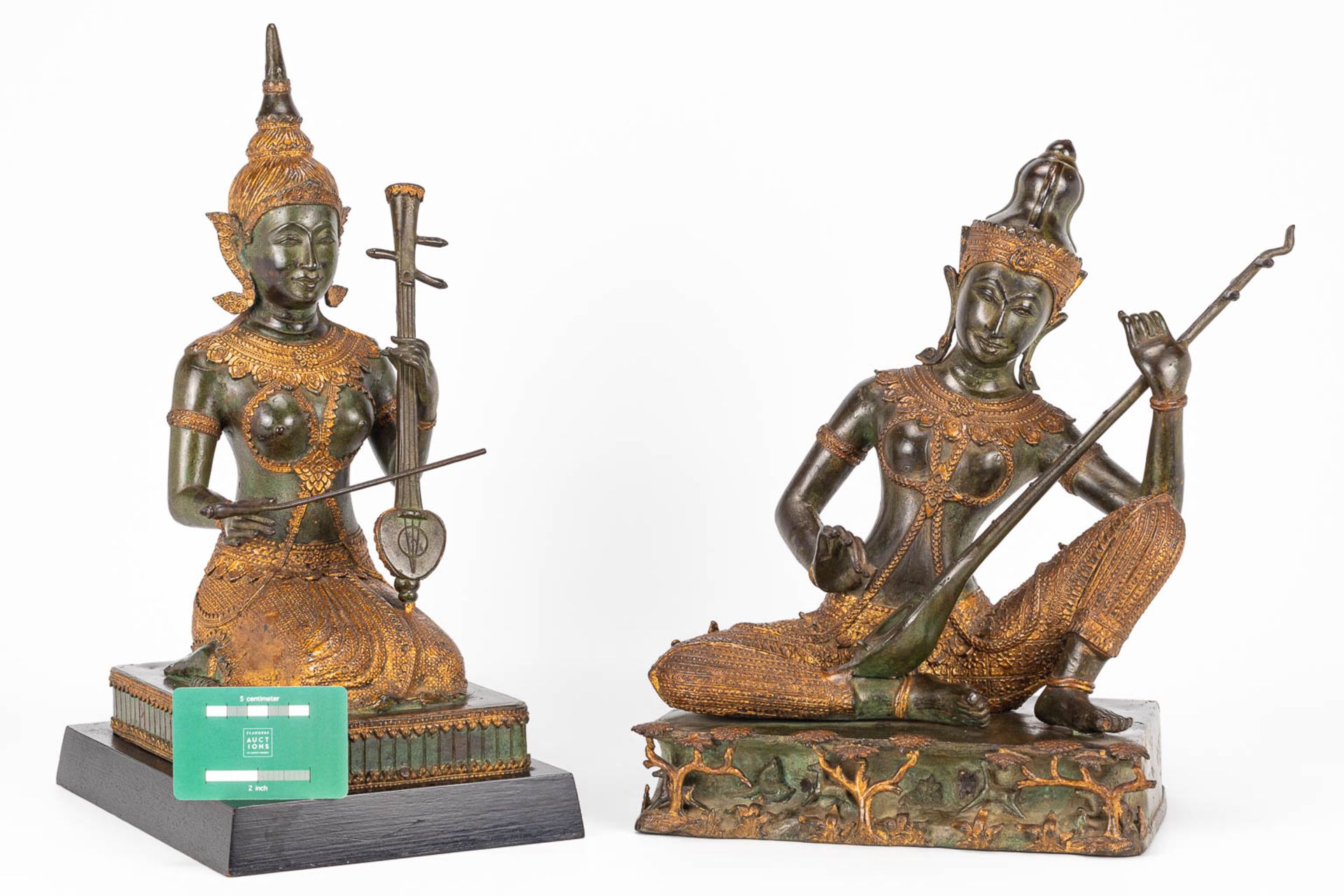 A collection of 2 oriental musical buddha's, made of metal. - Image 9 of 15