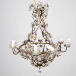 A large chandelier made of metal with glass flowers.