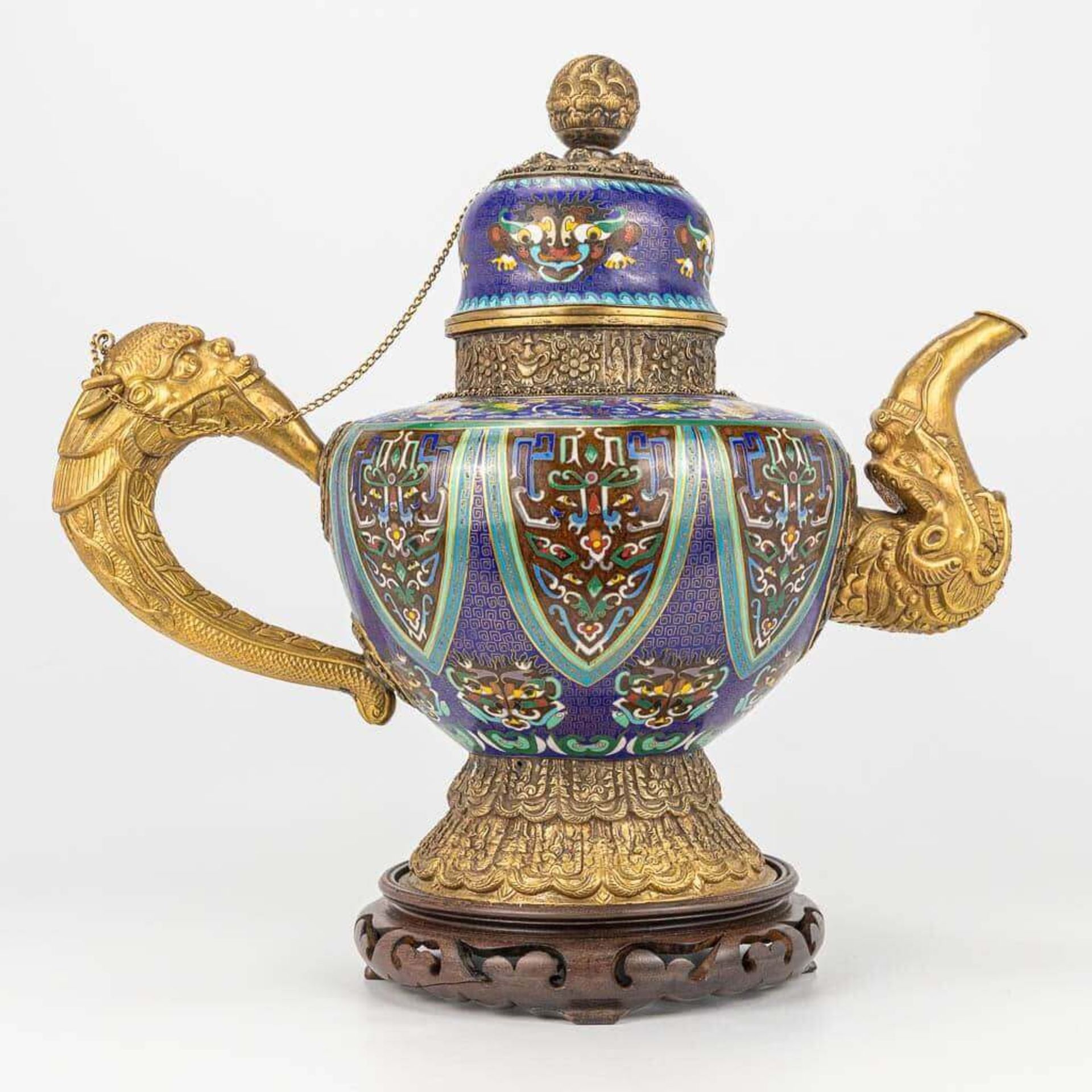 A Tibetan ceremonial ewer made of gilt bronze and finished with cloisonnŽ bronze.