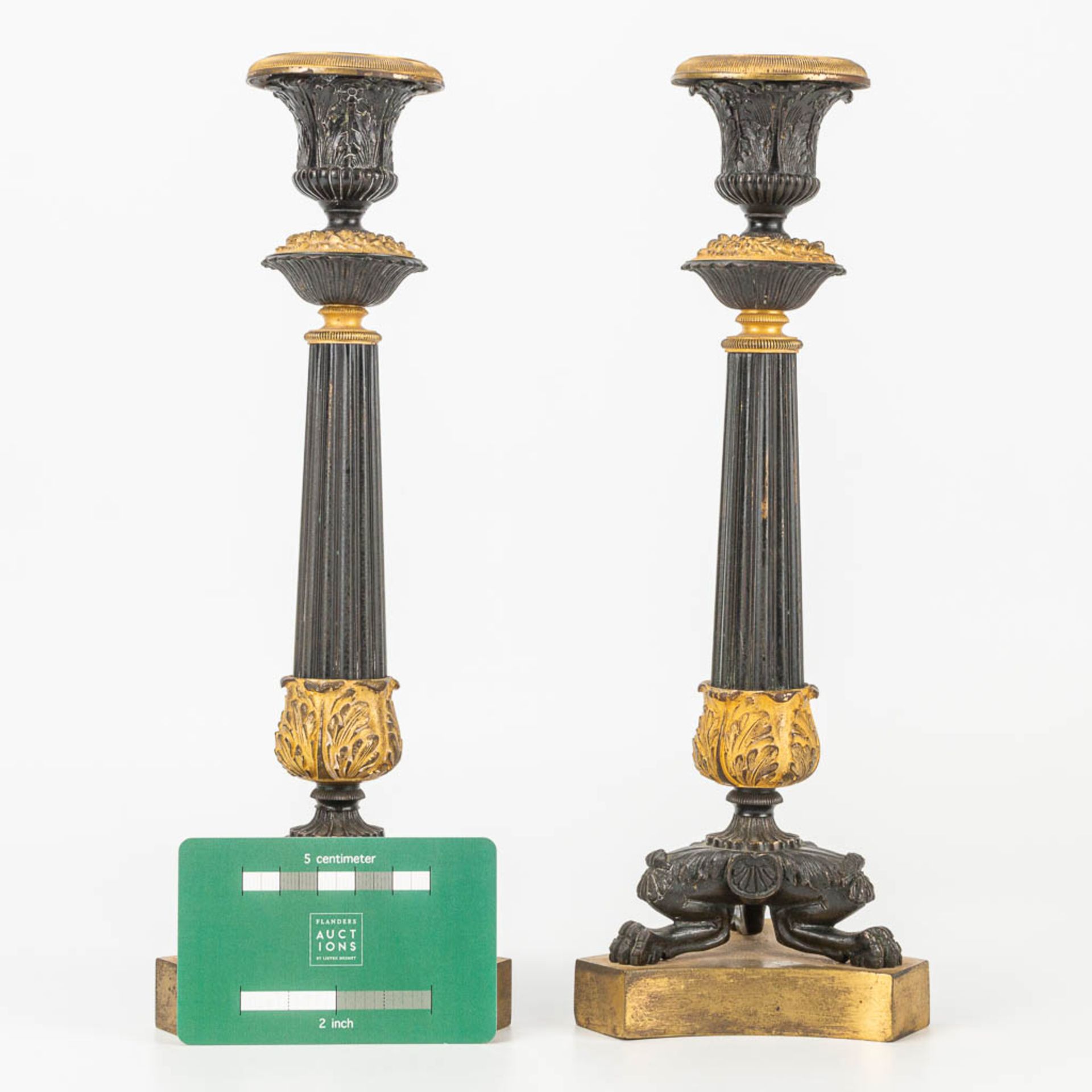 A pair of candlesticks made of gilt and patinated bronze in empire style. - Image 2 of 7