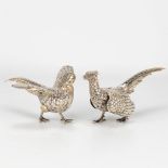 A collection of 2 pheasants made of silver.