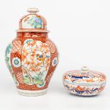 An assembled collection of Japanese porcelain, an Imari jar, and a Kutani vase with a lid.