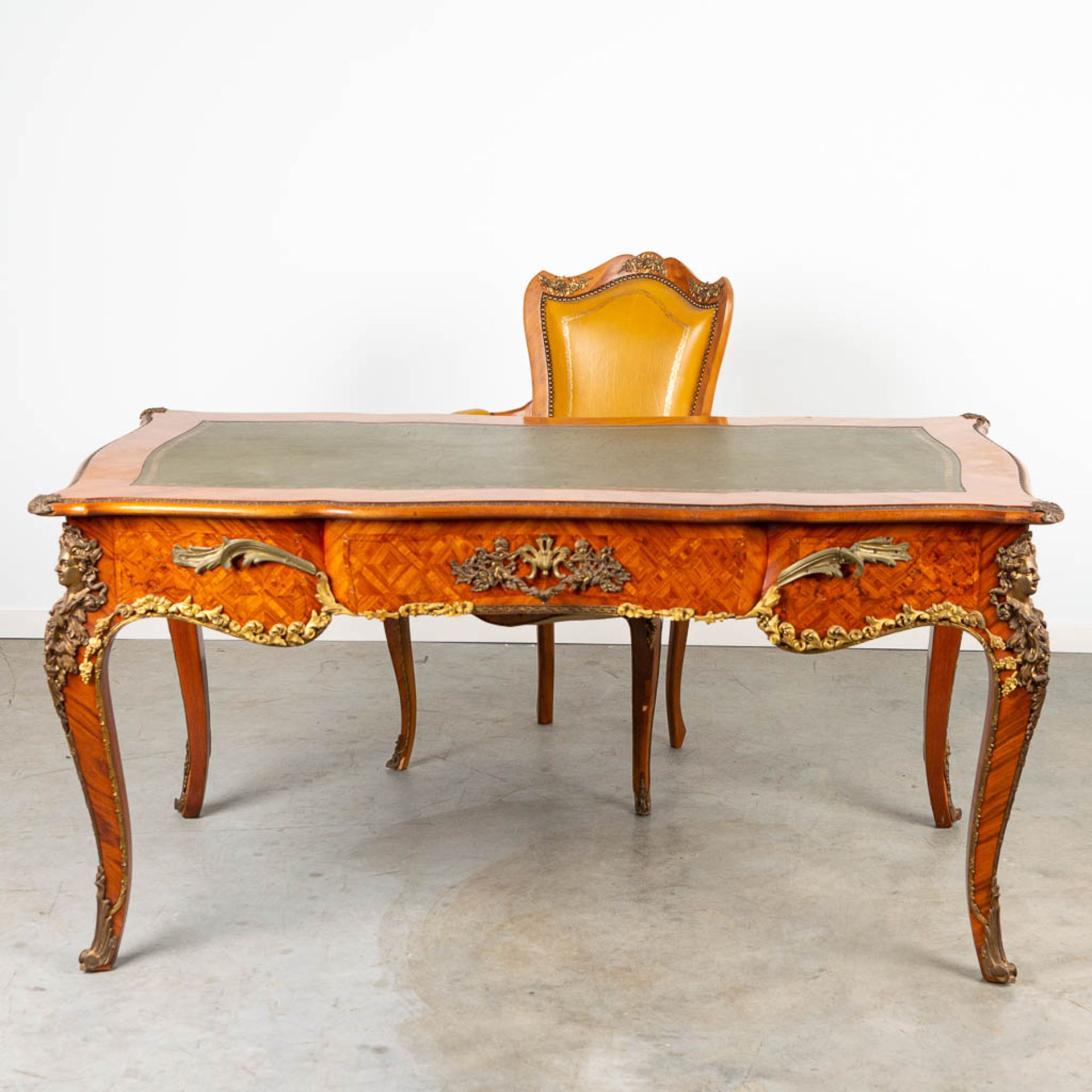 A desk and chair, mounted with bronze in Louis XV style and finished with marquetry bronze and leath