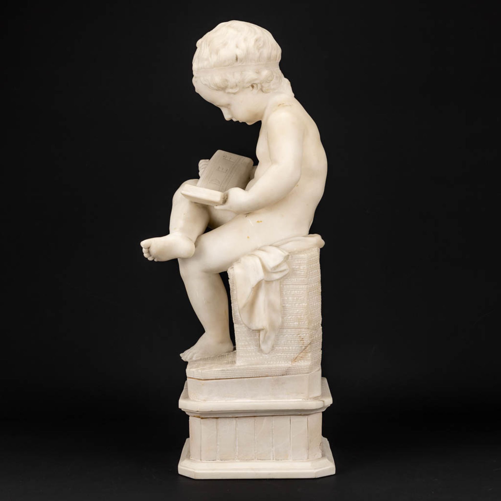 A statue of a reading boy made of alabaster. - Image 5 of 11