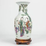 A vase made of Chinese porcelain decorated with ladies, children and bats