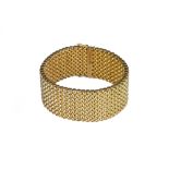 A bold and heavy gold weave link bracelet.