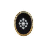 A Victorian diamond and onyx brooch.