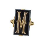 A yellow gold and onyx signet ring.