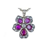 An early 20th century ruby and diamond flower pendant.