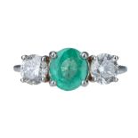 An emerald and diamond ring.