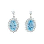 A pair of aquamarine and diamond earrings.