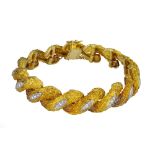 An 18 carat yellow gold and diamond bracelet.