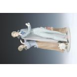 A Lladro Figure of a Gentleman & Lady,