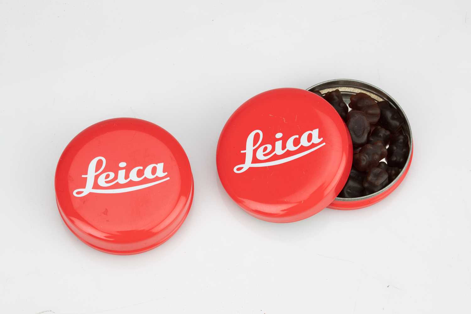 Two Leica Branded Tins Containing Gummy Bears,