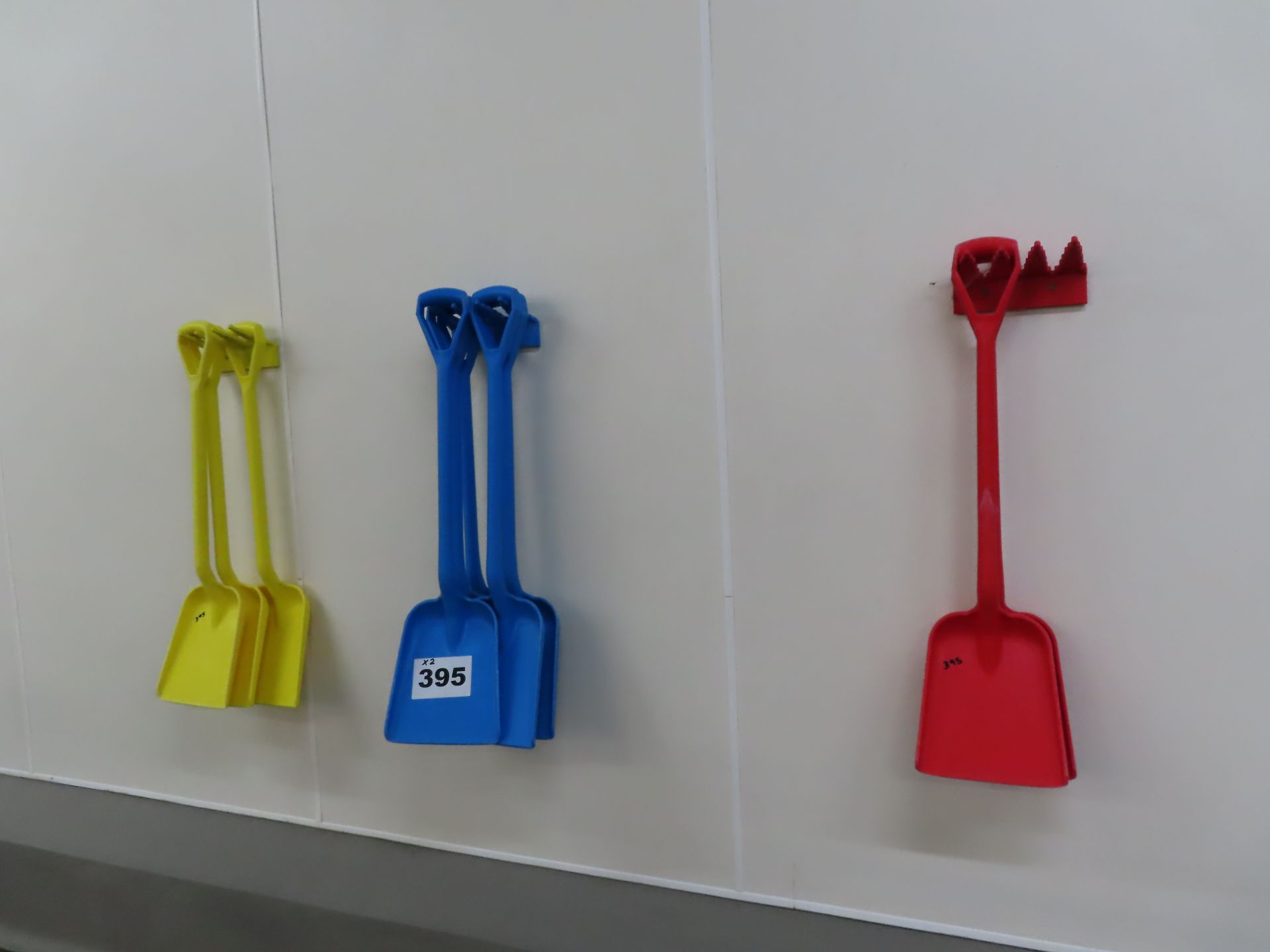 WALL MOUNTED SHOVEL HOLDERS.