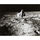 Apollo 11.- Buzz Aldrin at the seismic experiment and carrying parts of the EASEP experiment, …