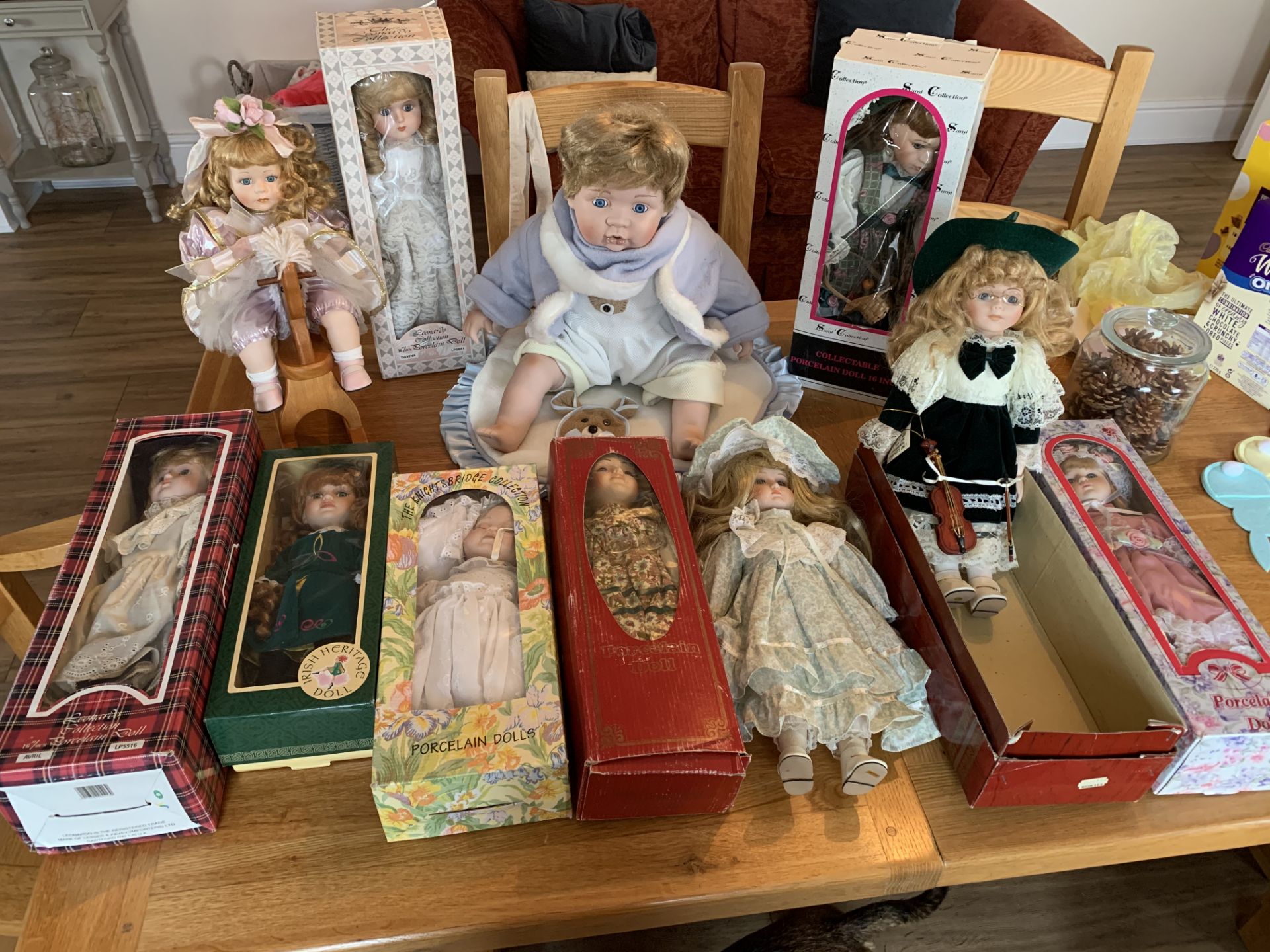 Box of 11 mainly boxed porcelain dolls