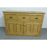 Pine cabinet with three drawers over a pair of panelled cupboard doors, on a plinth base, 103 x