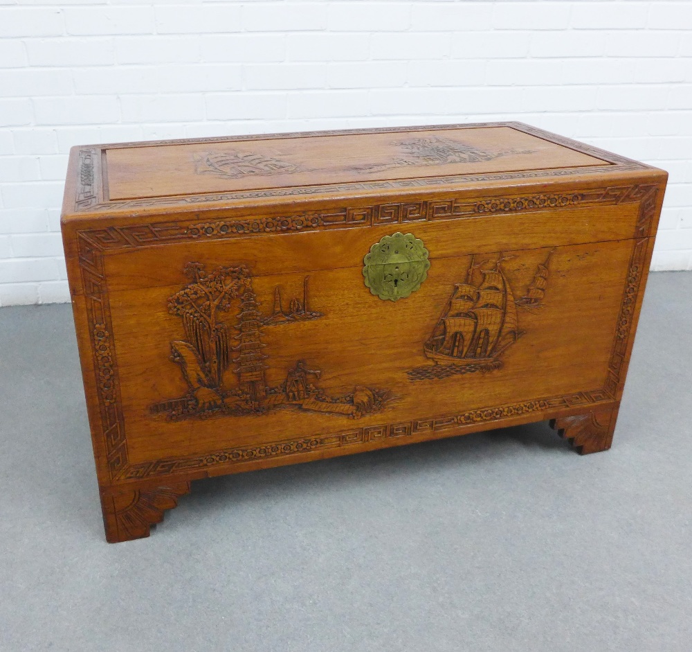 Camphor wood blanket box / storage trunk, with hinged lid and void interior, carved with a pagoda