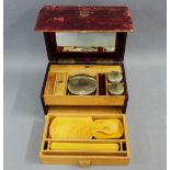 19th century red leather travelling vanity case with brass swing handle, the hinged top opening to