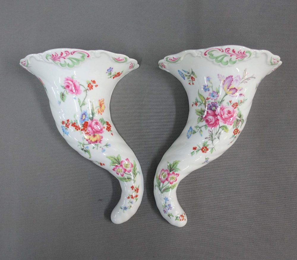 Pair of Royal Worcester porcelain cornucopia wall vases, with black printed backstamps, 25cm long (