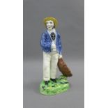 Early 19th century earthenware figure of a Fisherman, probably Portobello pottery.