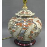 Satsuma table lamp base of lobed form and painted with pagodas and a blossom landscape, with