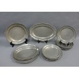 A collection of fourteen pewter plates and serving dishes, (14)