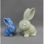 Two early 20th century rabbits to include a Sylvac style green painted plaster example and the other